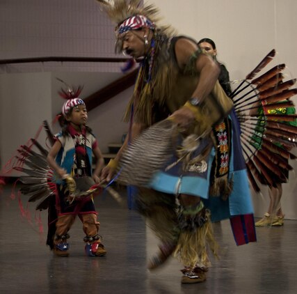 MARINE CORPS BASE HAWAII - Dr. David Bevett, a substance abuse counselor with Schofield Barracks and traditional Native American dancer from Cherokee and Shawnee bloodlines, dances with his son during Cultural Heritage Day at Kahuna’s Ballroom on Marine Corps Base Hawaii, March 1. The event, which will be held annually, highlights America’s diversity and common heritage on MCB Hawaii. (U.S. Marine Corps photo by Lance Cpl. Suzanna Lapi) 