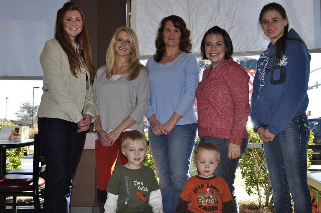 Caitlin Lewis, Marine Helicopter Squadron One family readiness officer, left, stands with the HMX-1 spouses and children who attended the Nighthawk Spouses’ Coffee Group March 4 in Stafford. The group meets twice a month as a way for HMX-1 spouses to meet and connect with other spouses with similar interests. (U.S. Marine Corps photo by Sgt. Rebekka S. Heite/Released)