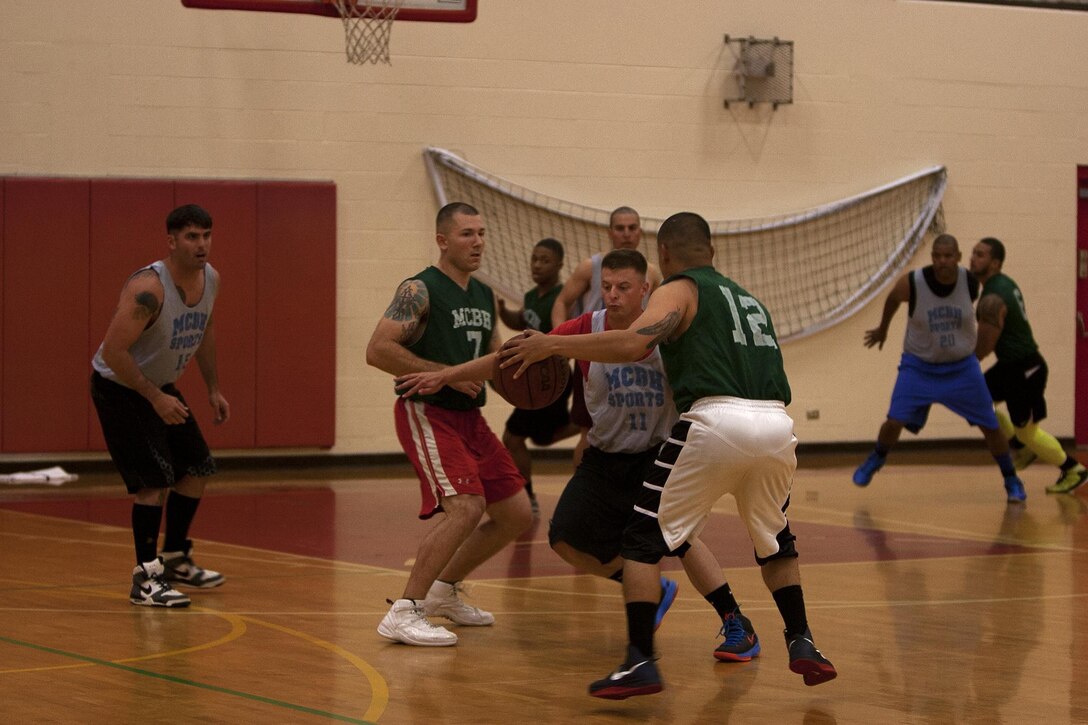 MARINE CORPS BASE HAWAII - Players from Combat Logistic Battalion 3 and Postal intramural basketball teams go head to head during an intramural basketball league game at Semper Fit Center gym, March 4. (U.S. Marine Corps photo by Lance Cpl. Suzanna Lapi) 