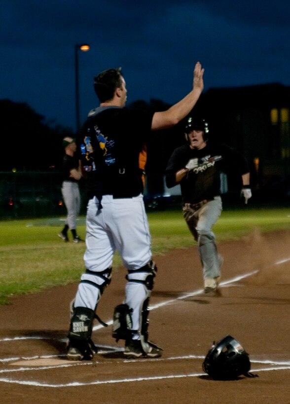 MARINE CORPS BASE HAWAII - Patrol Squadron 47 catcher Jonas Downing calls to his defensive team as 2nd Battalion, 3rd Marine Regiment Island Warriors pitcher Josh Beier charges toward home plate during an intramural baseball game at Riseley Field, March 5, 2013. The 2nd Bn., 3rd Marines Island Warriors defeated the VP-47 Golden Swordsmen, 8-4. (U.S. Marine Corps photo by Kristen Wong)