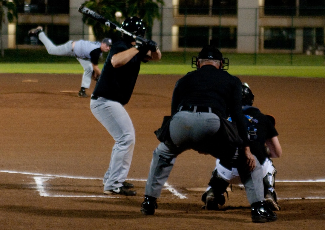 MARINE CORPS BASE HAWAII - Island Warriors catcher John Williams gets ready to hit the ball during an intramural baseball game at Riseley Field, March 5, 2013. The VP-47 Golden Swordsmen are 1-3 and the 2nd Bn., 3rd Marines Island Warriors are 2-2. The next intramural baseball game is scheduled for March 11 at 6:30 p.m. at Riseley Field. (U.S. Marine Corps photo by Kristen Wong)