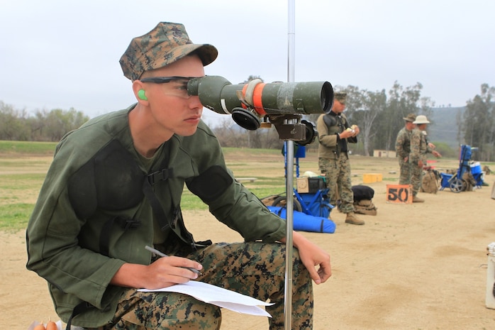 Lance Cpl. Jacob Arthur, a crew chief serving with 3rd Assault Amphibian Battalion and a native of Los Angeles, spots for his partner during the 2013 Western Division Matches here, March 5. Over the course of two weeks, the competitors receive coaching from members of the Marine Corps Shooting Team and shoot for score on both rifle and pistol ranges. The shooting consists of rapid fire, slow fire and one-handed pistol shooting, all on targets smaller than what is used during annual rifle qualification.