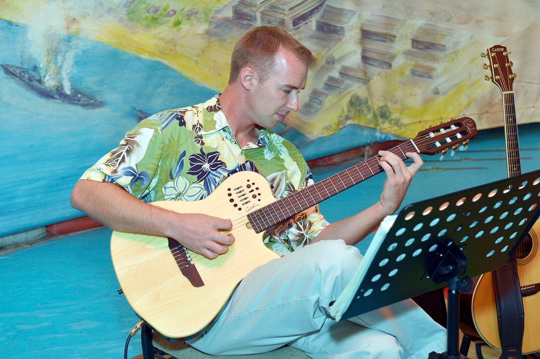 Senior Airman Aaron Kusterer soloing on the guitar. 