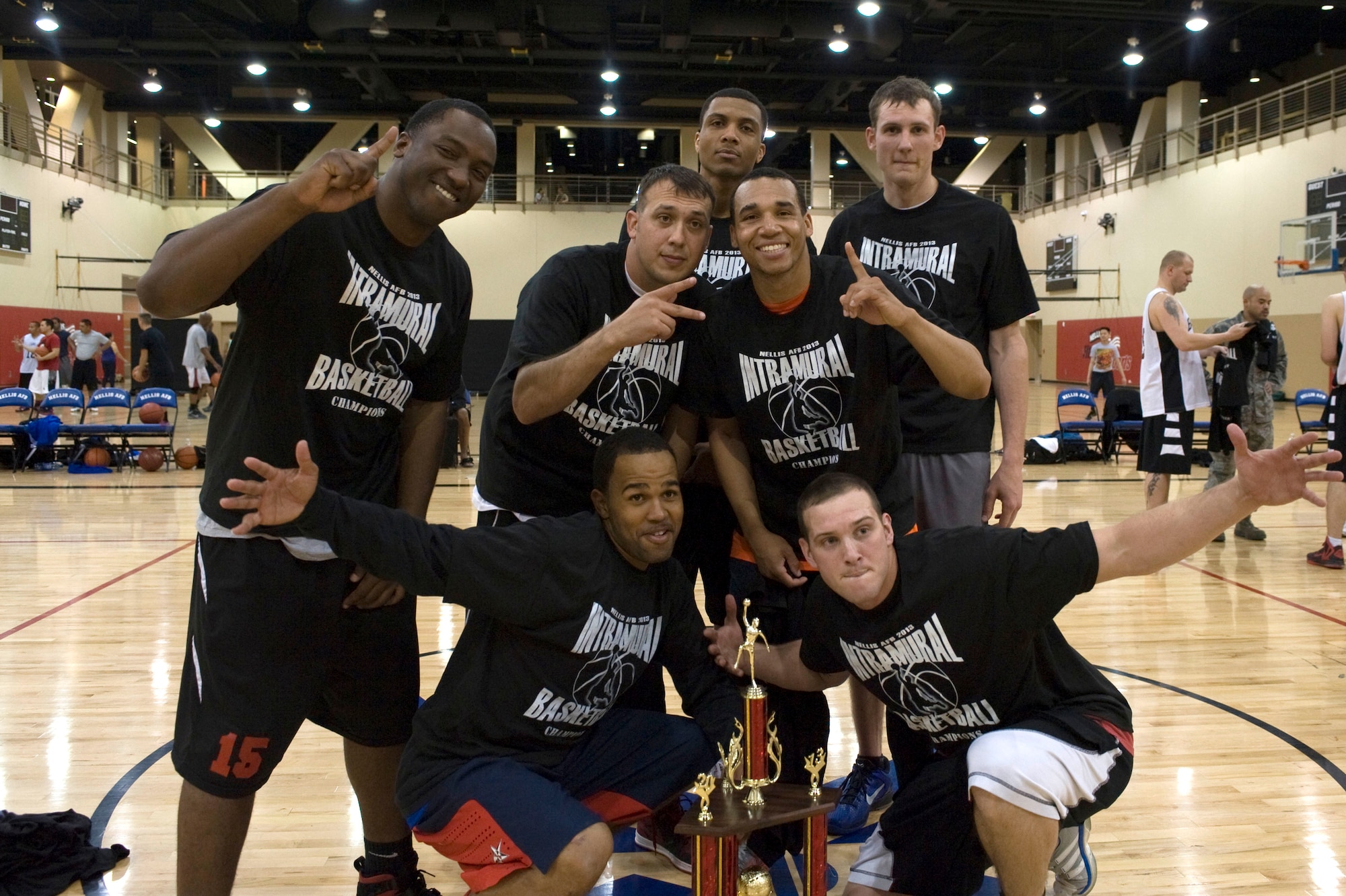 The 99th Civil Engineer Squadron celebrates winning the 2013 intramural basketball championship game against the 57th Aircraft Maintenance Squadron Mar. 7, 2013, at Nellis Air Force Base, Nev. The 99th CES defeated the 57th AMXS 61-55. (U.S. Air Force photo by Airman 1st Class Christopher Tam)