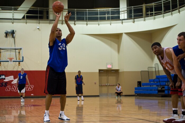 Kendal Dismute, 99th Civil Engineer Squadron, shoots a free throw during the intramural basketball championship game against the 57th Aircraft Maintenance Squadron Mar. 7, 2013, at Nellis Air Force Base, Nev. The 99th CES had a record of 6 wins and 2 losses going into the playoffs. (U.S. Air Force photo by Airman 1st Class Christopher Tam)