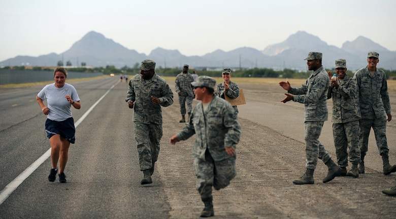 Members of the Desert Lightening Team cheer on a fellow Airman during the Wingman Warrior Day 5K at Davis-Monthan Air Force Base, Ariz., Sept. 28, 2012. (U.S. Air Force photo by Airman 1st Class Christine Griffiths/released)