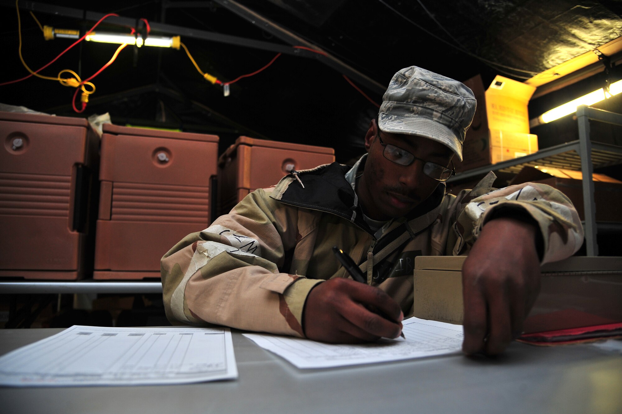 U.S. Air Force Senior Airman Walter Josephs, 4th Force Support Squadron fitness apprentice, makes note of how much food was prepared at the field kitchen during Operational Readiness Inspection CORONET WHITE on Seymour Johnson Air Force Base, N.C., Mar. 8, 2013. Field kitchen workers must keep a production log listing who cooked what food, the serving size of each food, as well as who performed taste tests. (U.S. Air Force photo/Airman 1st Class Aubrey White/Released)