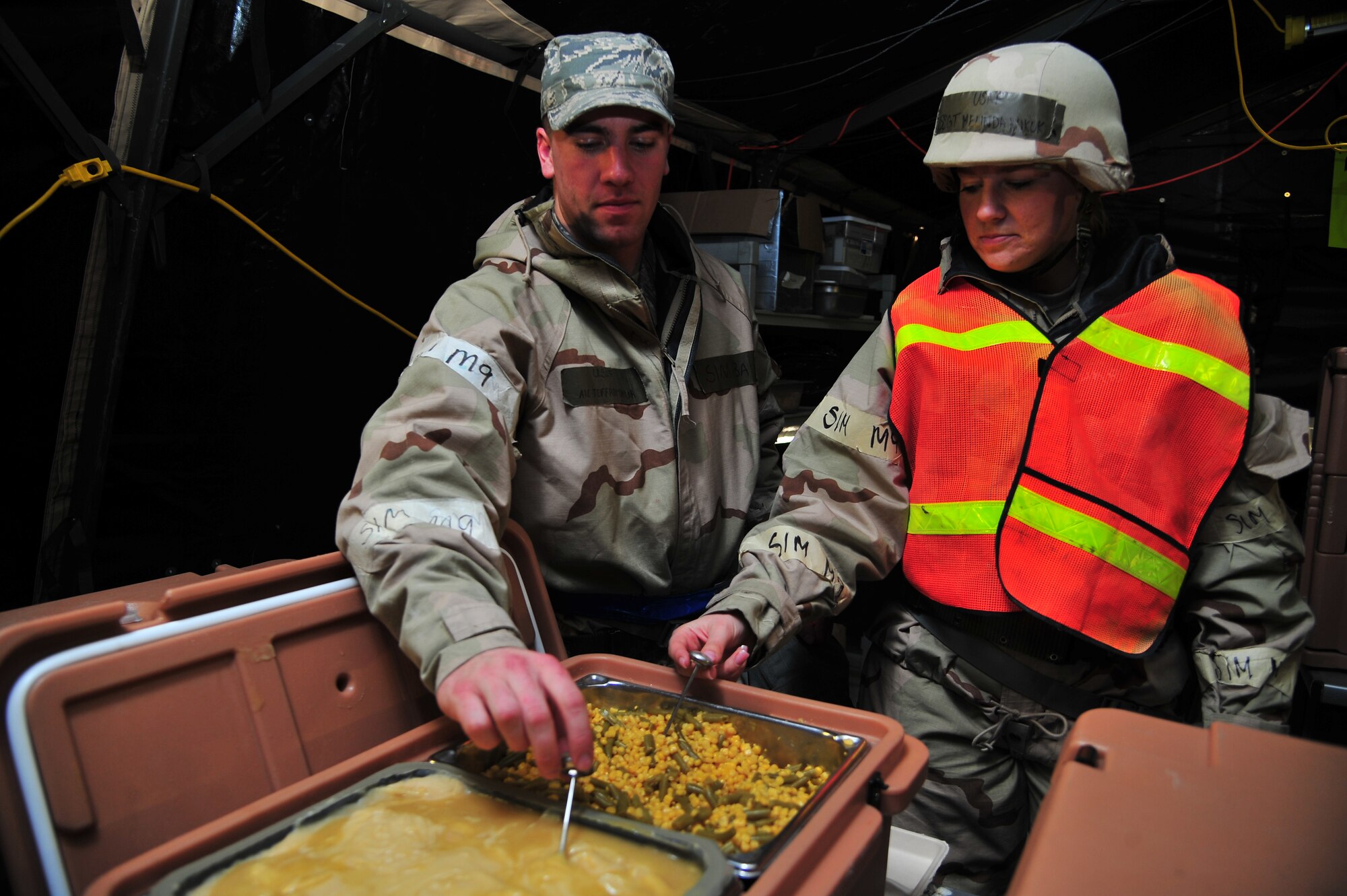 U.S. Air Force Airman 1st Class Jeffrey Taylor, 4th Force Support Squadron Fitness specialist, and Staff Sgt. Melinda Kukuk, 4th FSS food service accountant, check the temperature of a hot meal during Operational Readiness Inspection CORONET WHITE on Seymour Johnson Air Force Base, N.C., Mar. 8, 2013. ¬¬Prepared meals must be inspected routinely to ensure safe consumption. (U.S. Air Force photo/Airman 1st Class Aubrey White/Released)