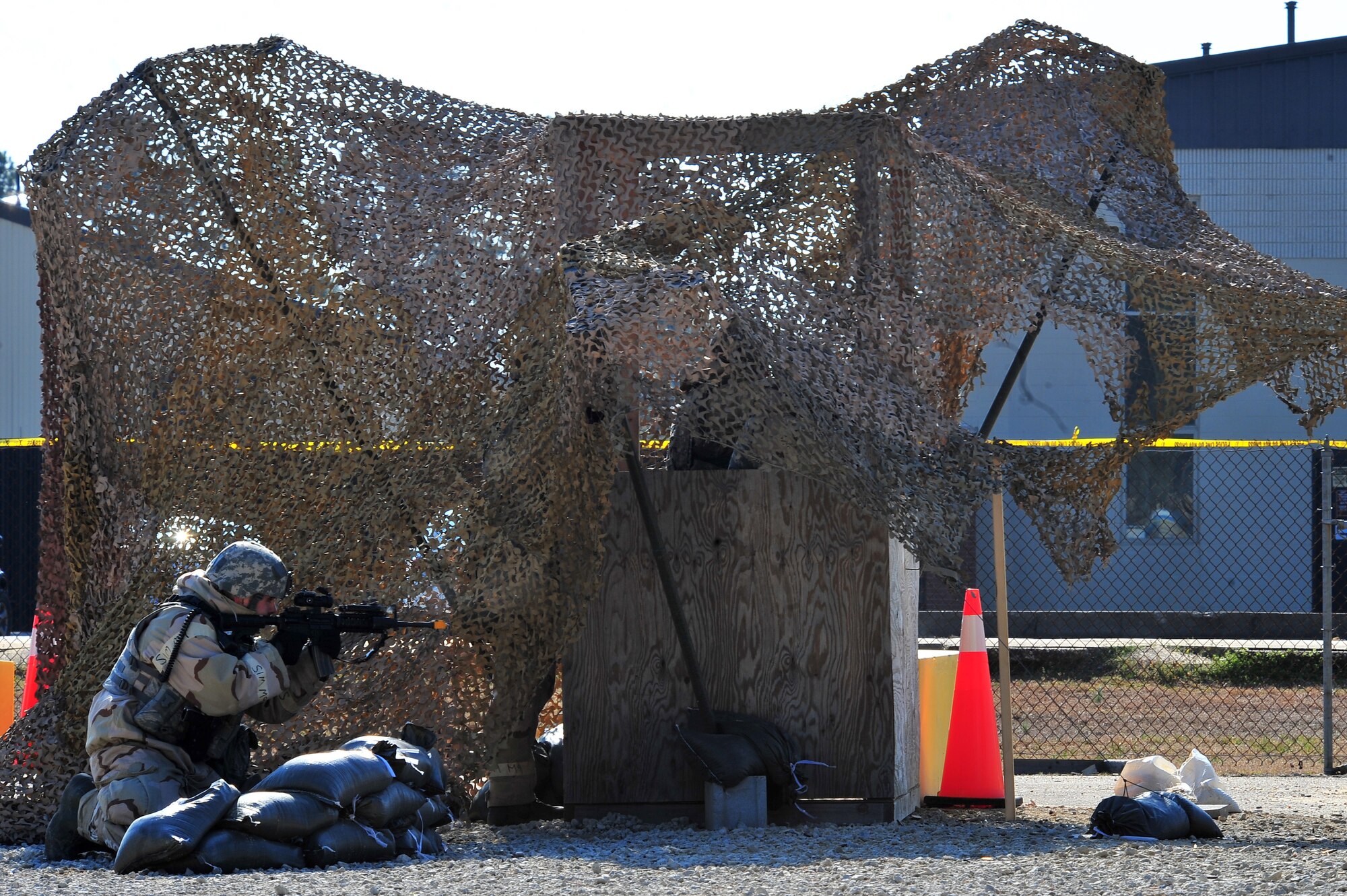 U.S. Air Force Senior Airman Nicholas Grewell, 4th Security Forces Squadron defender, fires at mock enemy personnel during Operational Readiness Inspection CORONET WHITE on Seymour Johnson Air Force Base, N.C., Mar. 8, 2013. Grewell provided back-up defense as enemy personnel attacked the base. (U.S. Air Force photo/Airman 1st Class Aubrey White/Released)