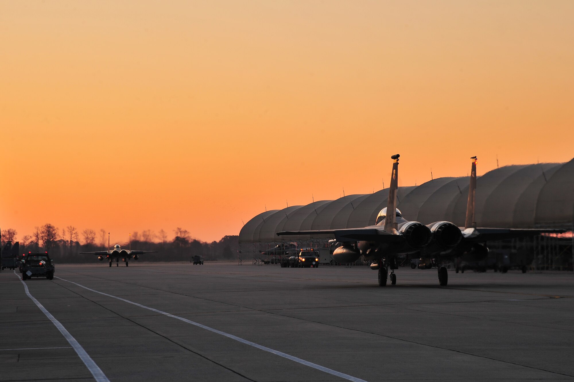 F-15E Strike Eagles taxi on the flight line prior to take-off at a simulated deployed location during Operational Readiness Inspection CORONET WHITE on Seymour Johnson Air Force Base, N.C., Mar. 8, 2013. The 4th Fighter Wing Airmen worked together to accomplish the mission, providing "Dominant Strike Eagle Airpower...Anytime Anyplace." (U.S. Air Force photo/Airman 1st Class Aubrey White/Released)