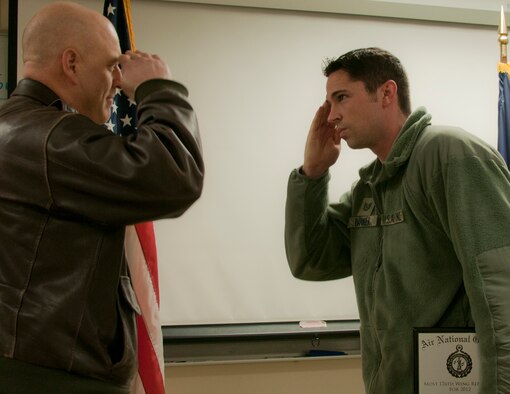 JOINT BASE ELMENDORF-RICHARDSON, Alaska -- Tech. Sgt. Jack Barker, a member of the  176th Security Forces Squadron, recieves a plaque for most wing referrals for 2012 on March 3 from the wing commander. "From the top down, recruiting is our top priority," said Col. Donald S. Wenke, the 176th Wing commander. "Every day, every year, until we meet 100 percent authorized end strenght." National Guard photo by Staff Sgt. N. Alicia Goldberger.