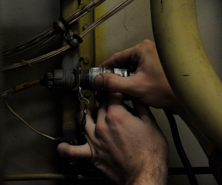 Airman 1st Class Sam Ritzman, 2nd Maintenance Squadron Avionics, hooks up power to a B-52H Stratofortress' electronic countermeasures prior to beginning a pressure test on Barksdale Air Force Base, La., March 8. The pressure test checks for the proper pressure levels within the ECMs as the system needs a certain amount of pressure to keep moisture and dirt out which could cause damage. (U.S. Air Force photo/Airman 1st Class Andrew Moua)