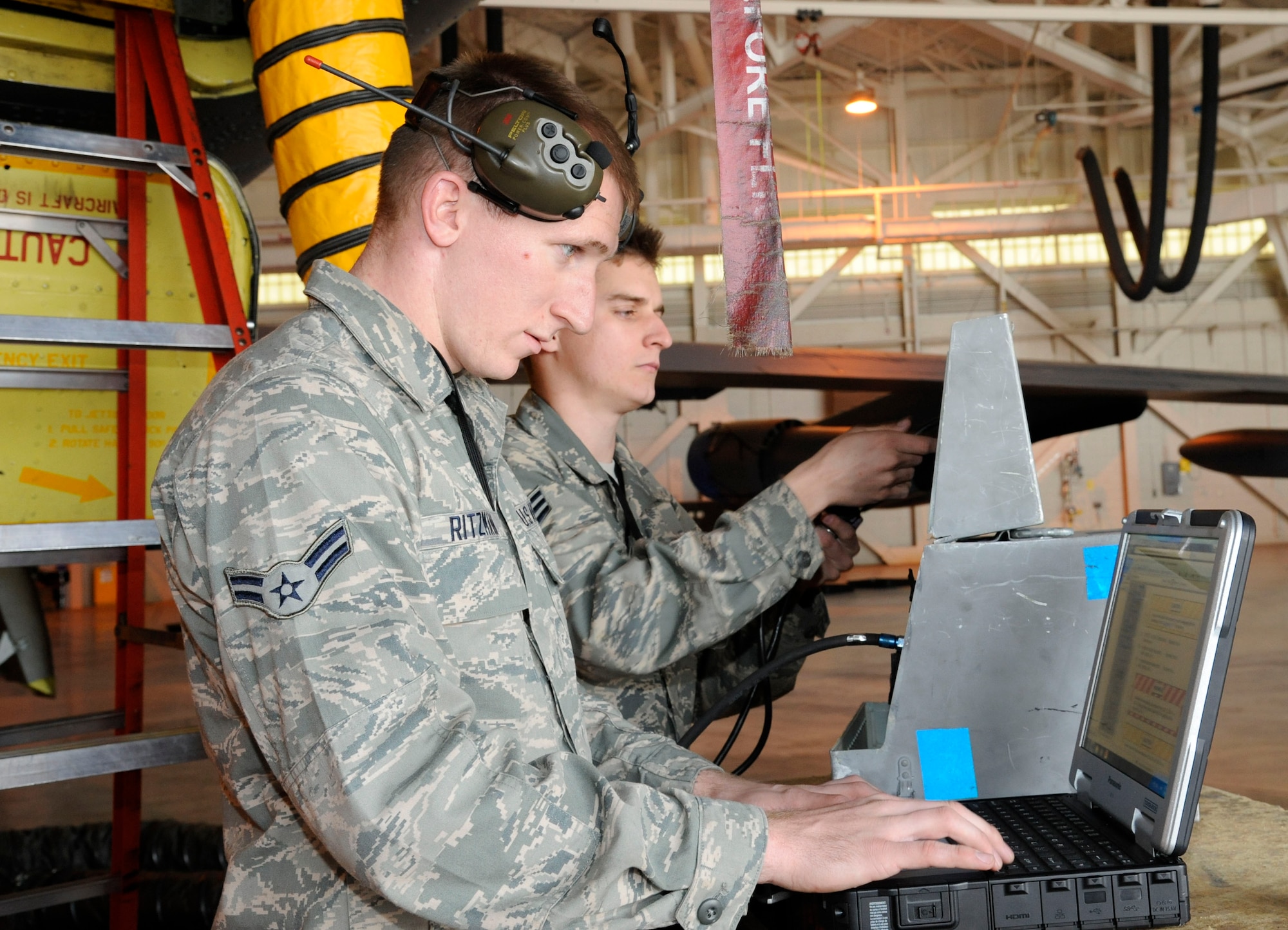Airman 1st Class Sam Ritzman, 2nd Maintenance Squadron Avionics, looks over a technical order as Senior Airman Heinz Bartnick, 2 MXS Avionics, prepares to test the electronic warfare systems of a B-52H Stratofortress on Barksdale Air Force Base, La., March 8. The electronic warfare systems help an aircraft evade and survive hostile fire by disrupting enemy radar and tracking systems. (U.S. Air Force photo/Airman 1st Class Andrew Moua)