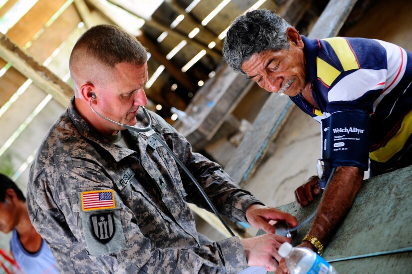 U.S. Army Sgt. Christopher Fussell, medical element medic, checks the blood pressure of a patient during a Medical Readiness Training Exercise in Marraganti, Panama March 1, 2013. Joint Task Force-Bravo partnered with the Panama Ministry of Health, Panama Ministry of Education and Servicio Nacional de Fronteras to exercise their expeditionary medical and mission command capabilities in preparation for future disaster relief events. (U.S. Air Force photo by Capt. Rebecca Heyse)