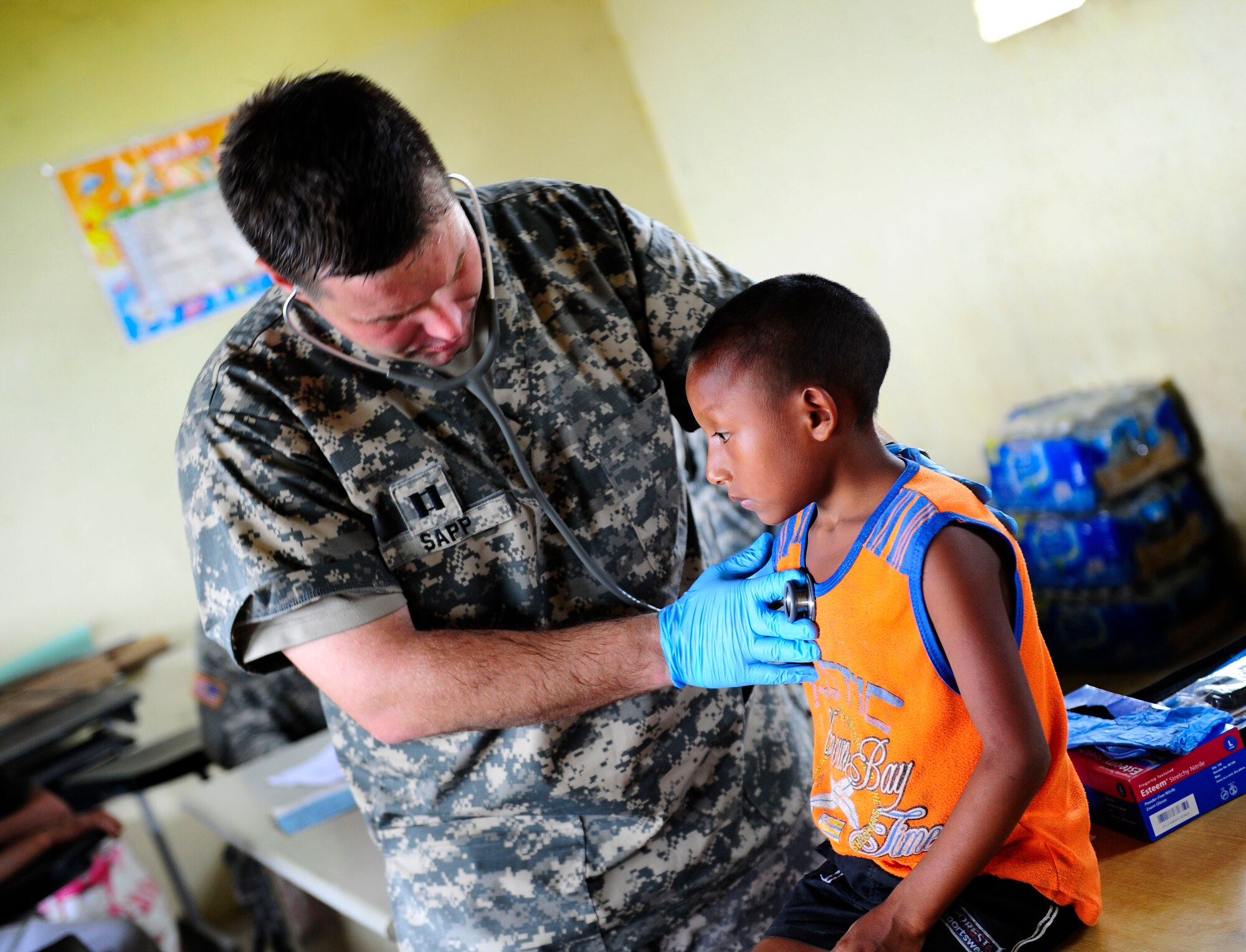 U.S. Army Capt. Andre Sapp, medical element physician's assistant, examines a resident of Uala, Panama Feb. 27, 2013. Joint Task Force-Bravo partnered with Panamanian government organizations to bring general medical and dental care as part of a Medical Readiness Training Exercise. MEDRETEs allow JTF-Bravo to exercise their expeditionary medical and mission control capabilities in preparation for future disaster relief events while supporting regional governments efforts to bring medical care to their populations. (U.S. Air Force photo by Capt. Rebecca Heyse)