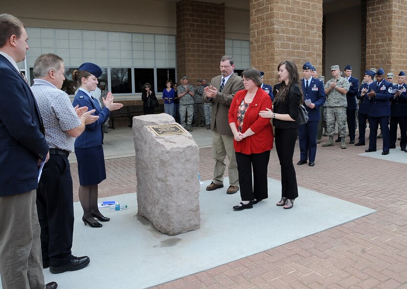 Family of the late Senior Airman Bryan Bell, 2nd Civil Engineer Squadron Explosive Ordnance Disposal flight, unveils a plaque in honor of Bell during a dedication ceremony at the SrA Bryan Bell Fitness Center on Barksdale Air Force Base, La., March 8. Bell, a member of the 2nd Civil Engineer Squadron Explosive Ordnance Disposal flight, was killed in action in Afghanistan by an improvised explosive device in 2012 while supporting Operation Enduring Freedom. (U.S. Air Force/Staff Sgt. Amber Ashcraft)