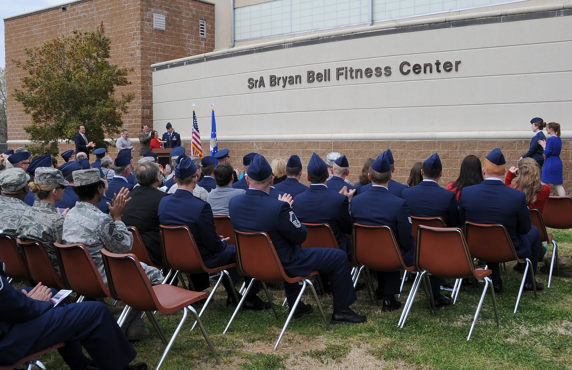 Family of the late Senior Airman Bryan Bell, 2nd Civil Engineer Squadron Explosive Ordnance Disposal flight, unveils the new name of the Fitness Center during a dedication ceremony in honor of Bell on Barksdale Air Force Base, La., March 8. Bell was killed in action in Afghanistan by an improvised explosive device in 2012 while supporting Operation Enduring Freedom. (U.S. Air Force/Staff Sgt. Amber Ashcraft)
