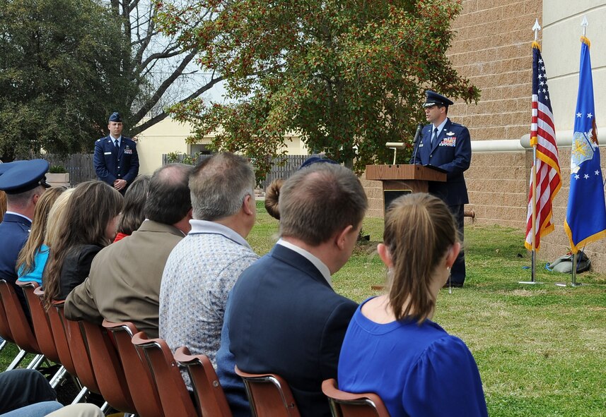 Col. Andrew Gebara, 2nd Bomb Wing commander, speaks during a dedication ceremony to re-name the Fitness Center to the SrA Bryan Bell Fitness Center on Barksdale Air Force Base, La., March 8. Bell, a member of the 2nd Civil Engineer Squadron Explosive Ordnance Disposal flight, was killed in action in Afghanistan by an improvised explosive device in 2012 while supporting Operation Enduring Freedom. (U.S. Air Force/Staff Sgt. Amber Ashcraft)