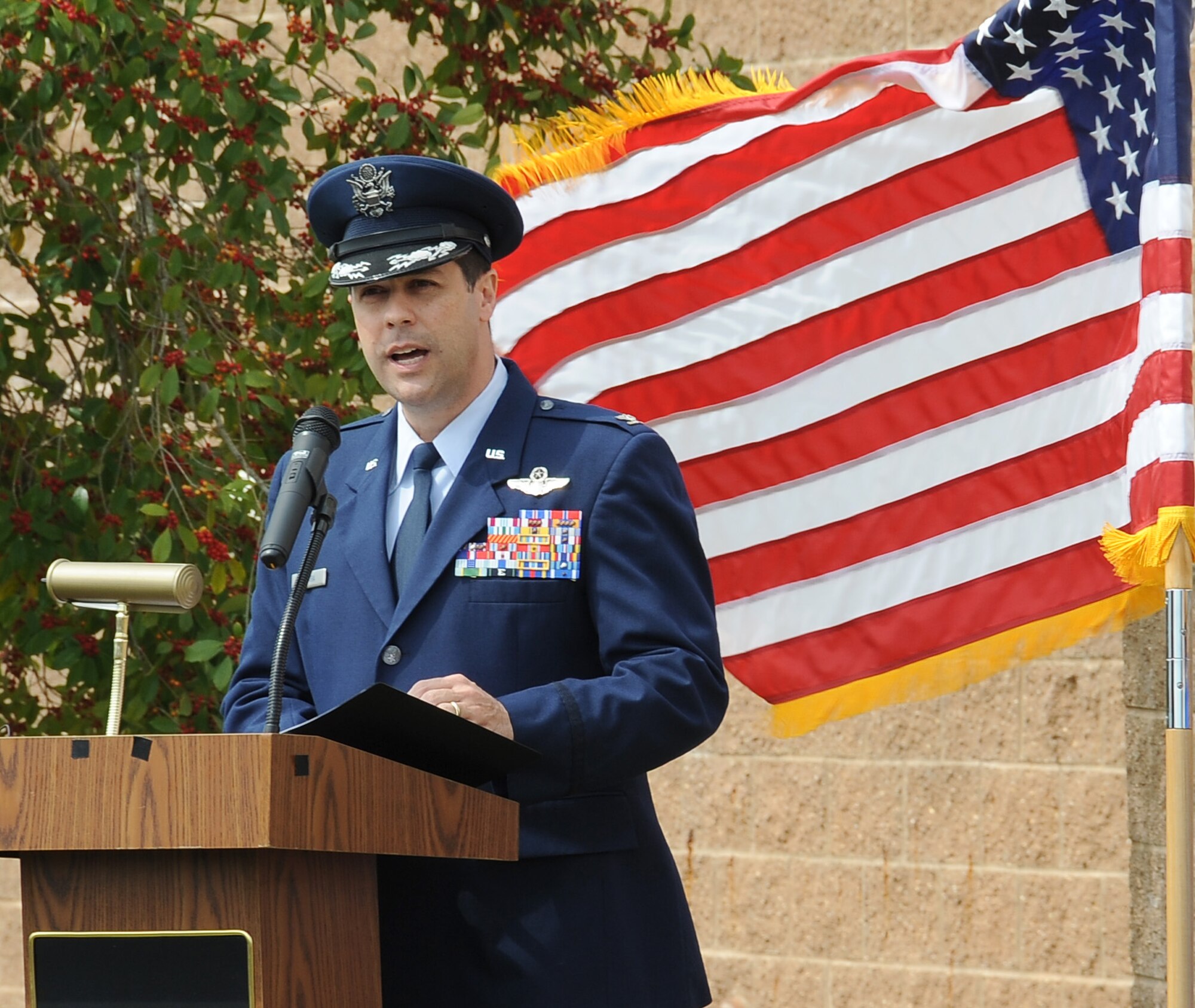 Col. Andrew Gebara, 2nd Bomb Wing commander, speaks during a dedication ceremony to re-name the Fitness Center to the SrA Bryan Bell Fitness Center on Barksdale Air Force Base, La., March 8. Bell, a member of the 2nd Civil Engineer Squadron Explosive Ordnance Disposal flight, was killed in action in Afghanistan by an improvised explosive device in 2012 while supporting Operation Enduring Freedom. (U.S. Air Force/Staff Sgt. Amber Ashcraft)