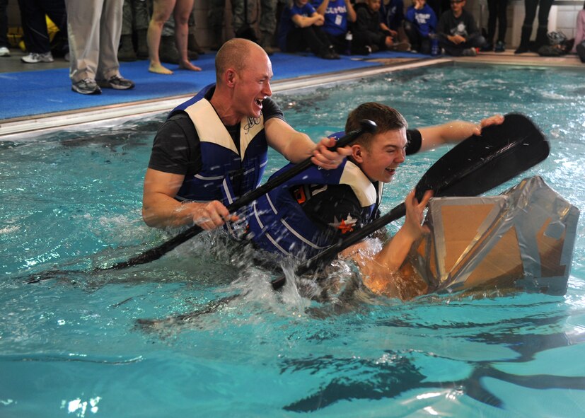 Master Sgt. Keelan Rasmusson, left, and Senior Airman Nikolai Smirnoff, from
the 319th Comptroller Squadron, try to keep their cardboard boat from
sinking during the "Frosty the Sailor Boat Race," Feb. 21, 2013, at Grand
Forks Air Force Base, N.D. The boat race was the last competition of the
2013 Winter Bash. (U.S. Air Force photo/Airman 1st Zachia Roberson)
