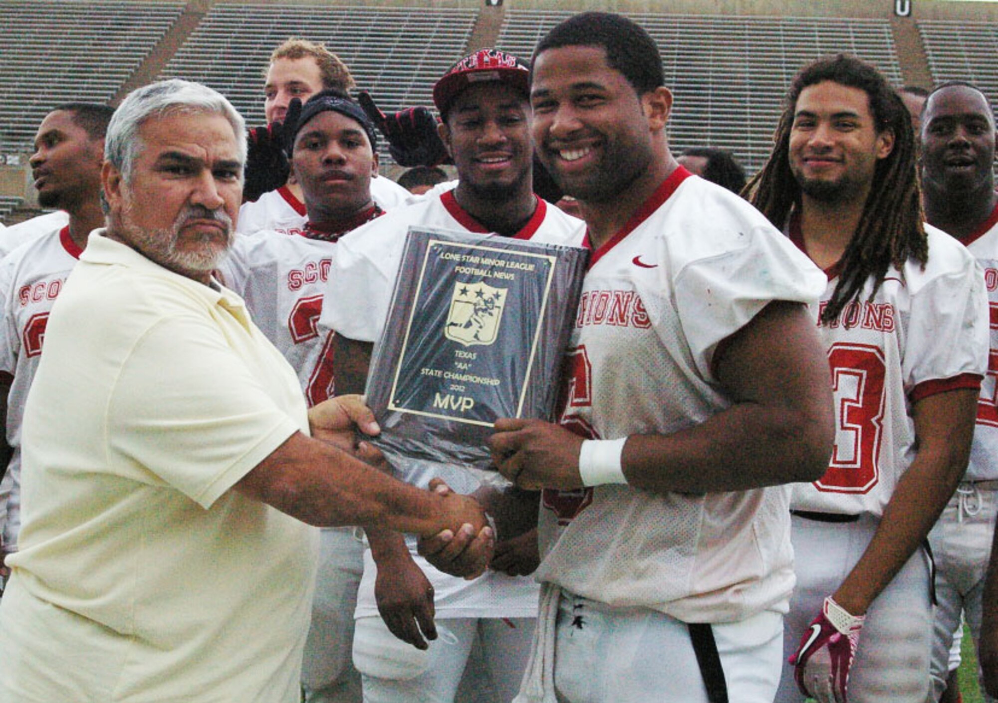 DALLAS, Texas-- Rene Torres, Lonestar Minor League News, awards Senior Airman Clifton Gathers, 17th Comptroller Squadron, with the most valuable player award. Gathers is one of the top three semi-professional football running backs in the country. (Courtesy photo) 