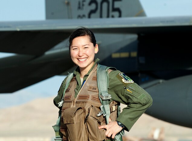 Capt. Kari Asai, an F-15E weapons officer assigned to the 492nd Fighter Squadron, RAF Lakenheath, England, stands in front of her aircraft following a training mission during Red Flag 13-3, March 6 at Nellis Air Force Base, Nev. Asai’s unit is working with allied nations to gain combat experience over the skies of Nevada’s Test and Training Range. (U.S. Air Force photo by Benjamin Newell)