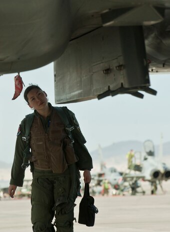 Capt. Kari Asai, an F-15E weapons officer assigned to the 492nd Fighter Squadron, RAF Lakenheath, England, examines her aircraft following training during Red Flag 13-3 March 6 at Nellis Air Force Base, Nev. Asai and her pilot, 1st Lt. Justin Miller, examined the aircraft after flying over the 2.9 million acre Nevada Test and Training Range, where Red Flag is held. (U.S. Air Force photo by Benjamin Newell)