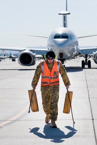 Royal Australian Air Force No. 2 Squadron Leading Aircraftman Doug Ansel, aircraft technician, removes the E-7A Wedgetail aircraft chalks prior to marshaling onto the Nellis Air Force Base, Nev. flight line Feb. 27, 2013. Red Flag is one of a series of advanced training programs administered by the United States Air Force Warfare Center. (U.S. Air Force photo by Lawrence Crespo)