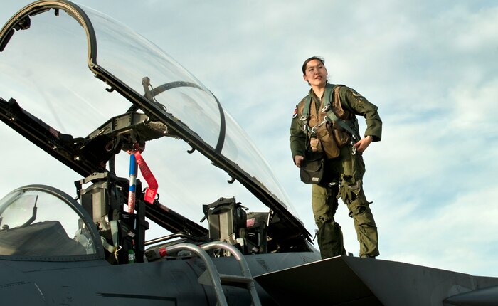 Capt. Kari Asai, F-15E weapons officer assigned to the 492nd Fighter Squadron, RAF Lakenheath, England, egresses from her aircraft following training during Red Flag 13-3 March 6 at Nellis Air Force Base, Nev. Weapons officers are charged with monitoring targets and selecting ordnance during combat. (U.S. Air Force photo by Benjamin Newell)