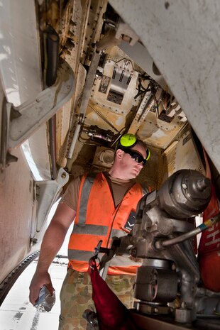Royal Australian Air Force No. 2 Squadron Leading Aircraftman Doug Ansel, aircraft technician, inspects the landing gear of an E-7A Wedgetail aircraft prior to a Red Flag training mission Feb. 27, 2013. Red Flag is conducted on the Nevada Test and Training Range and serves as an opportunity for allied air forces to train in realistic combat simulations alongside their counterparts from U.S. Air Forces. (U.S. Air Force photo by Lawrence Crespo)