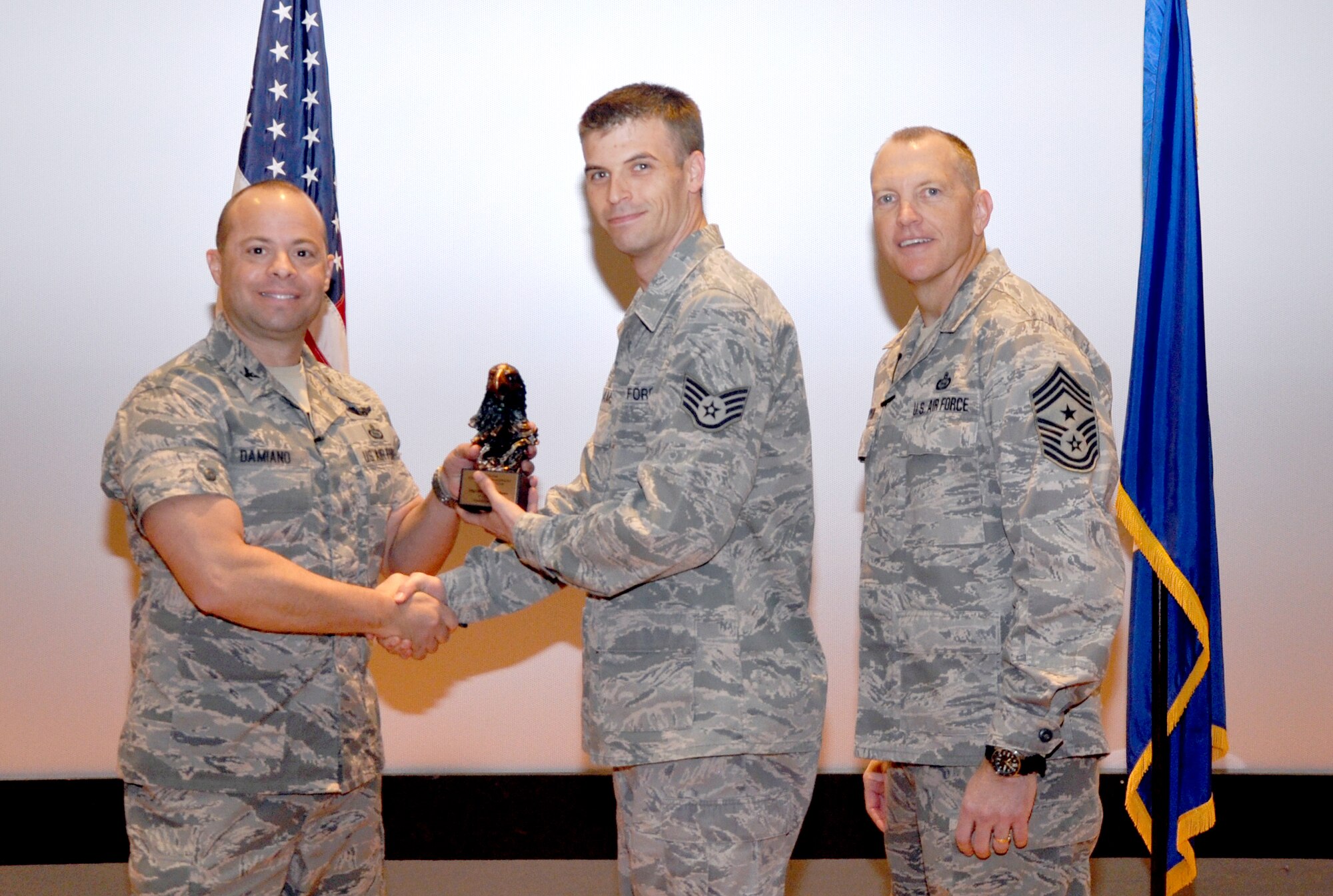 GOODFELLOW AIR FORCE BASE, Texas— Col. Mark Damiano, 17th Training Wing Commander, presents the Air Education and Training Command Financial Management NCO of the Year 2012 award to Staff Sgt. Michael Williams, 17th Comptroller Squadron, during the 17th TRW Commander’s Call at the base theater, March 7. (U.S. Air Force photo/1st Lt. Leanne Hedgepeth) 