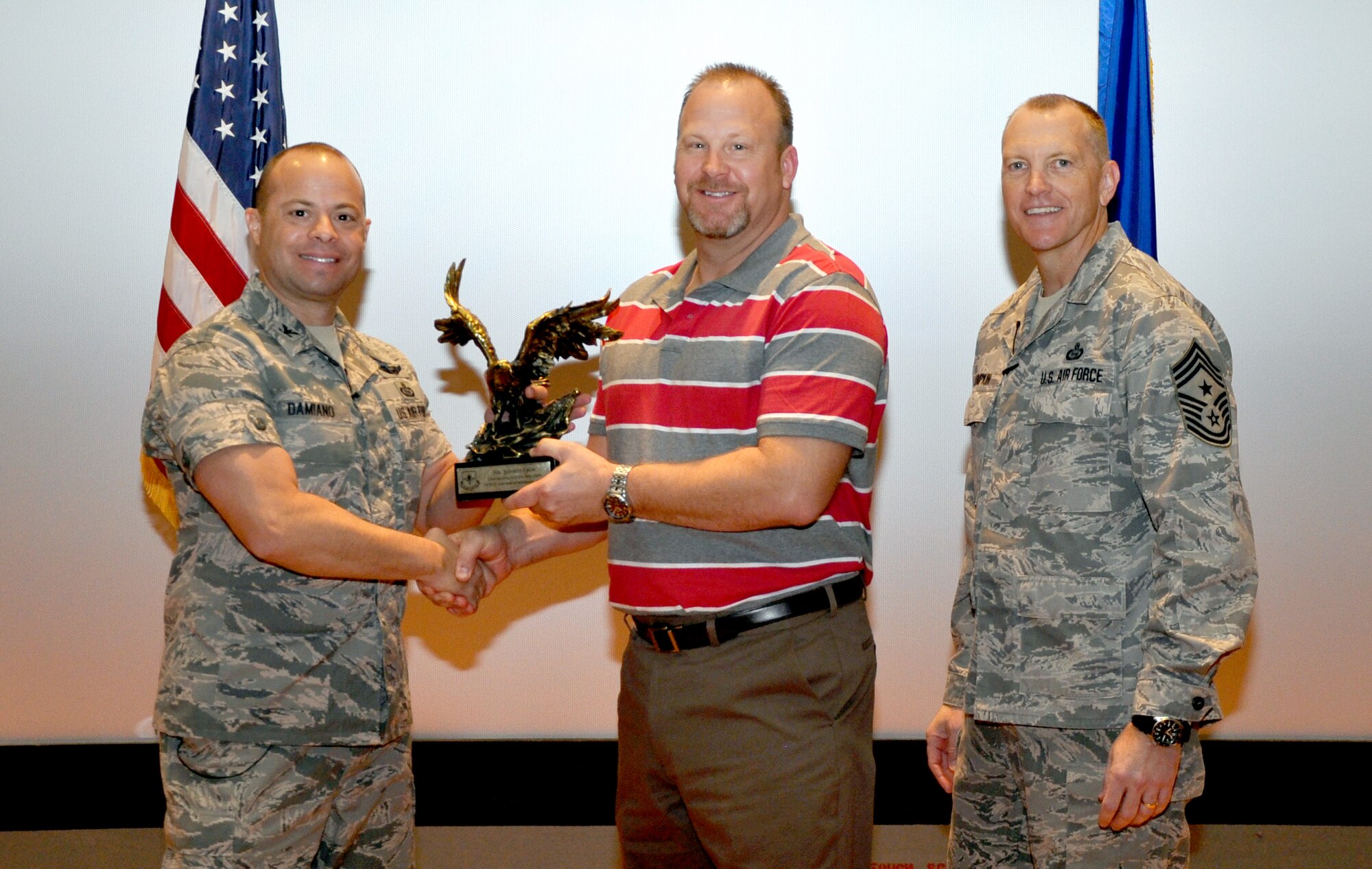 GOODFELLOW AIR FORCE BASE, Texas— Col. Mark Damiano, 17th Training Wing Commander, presents the Outstanding Civilian Specialist of the Year award to Jeffrey Crim, 17th Communications Squadron, during the 17th TRW Commander’s Call at the base theater, March 7. (U.S. Air Force photo/1st Lt. Leanne Hedgepeth) 