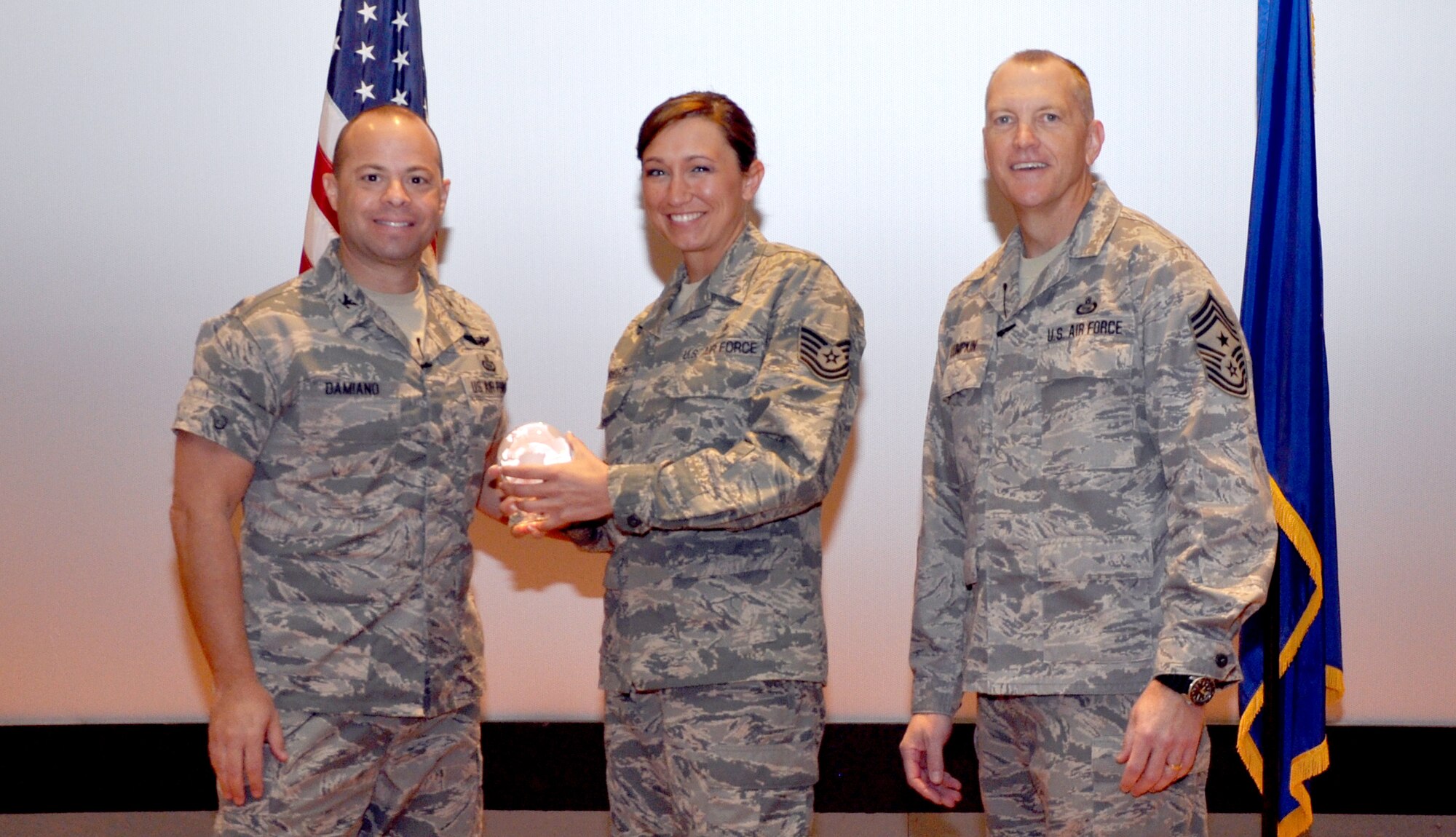 GOODFELLOW AIR FORCE BASE, Texas—Col. Mark Damiano, 17th Training Wing Commander, presents the Air Education and Training Command Outstanding Enlisted Health Services Management Noncommissioned Officer of the Year award to Tech. Sgt. Jamie Wright, 17th Medical Support Squadron, during the 17th TRW Commander’s Call at the base theater, March 7. (U.S. Air Force photo/1st Lt. Leanne Hedgepeth) 