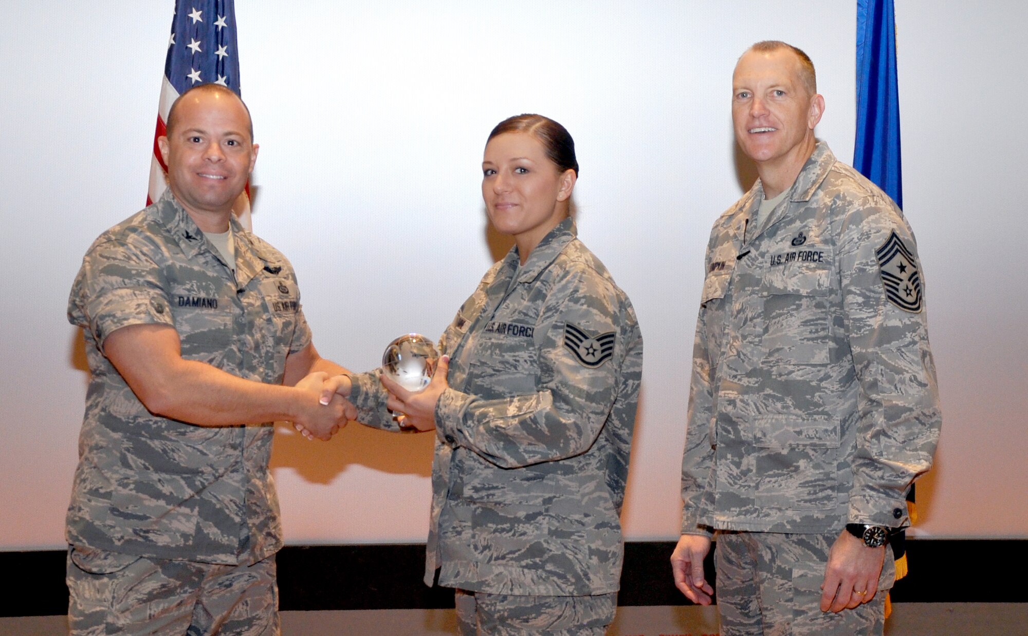 GOODFELLOW AIR FORCE BASE, Texas— Col. Mark Damiano, 17th Training Wing Commander, presents the Air Education and Training Command Outstanding Dental Airman of the Year award to Staff Sgt. Jennifer Romine, 17th Medical Operations Squadron, during the 17th TRW Commander’s Call at the base theater, March 7. (U.S. Air Force photo/1st Lt. Leanne Hedgepeth) 