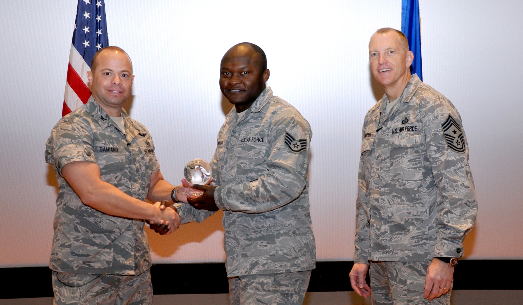GOODFELLOW AIR FORCE BASE, Texas— Col. Mark Damiano, 17th Training Wing Commander, presents the Air Education and Training Command Outstanding Aerospace Medicine Airman of the Year award to Staff Sgt. Blaise Muluh, 17th Medical Operations Squadron, during the 17th TRW Commander’s Call at the base theater, March 7. (U.S. Air Force photo/1st Lt. Leanne Hedgepeth) 