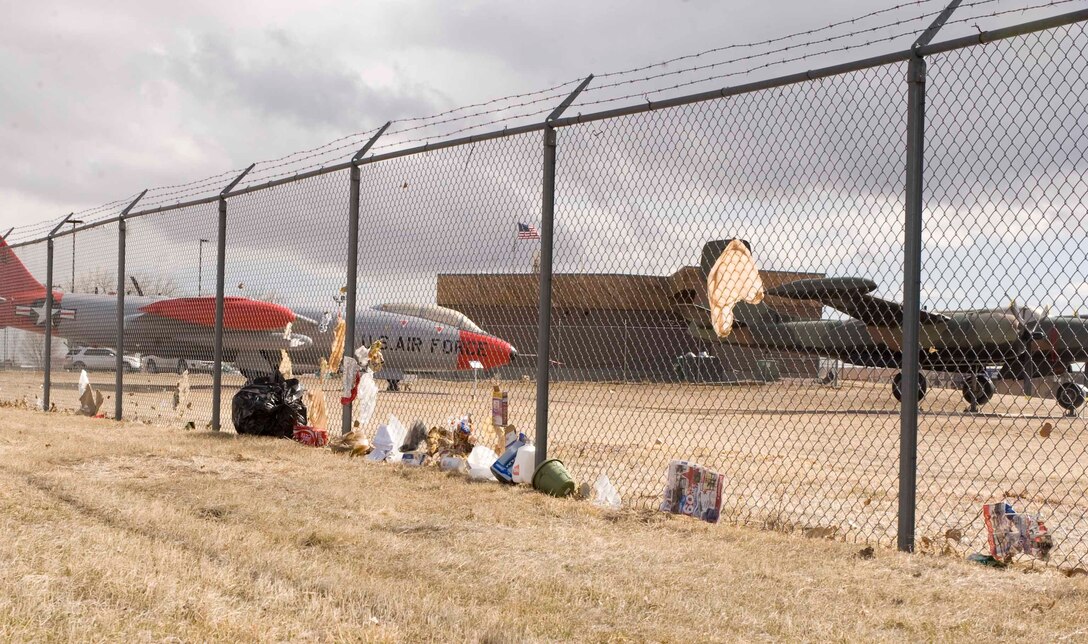 Unsecured trash is blown against the fences along the border of Ellsworth Air Force Base, S.D., March 8, 2013. Due to strong local winds, trash cans need to be secured to prevent accumulation of loose trash around the base. (U.S. Air Force photo by Airman 1st Class Anania Tekurio/Released)
