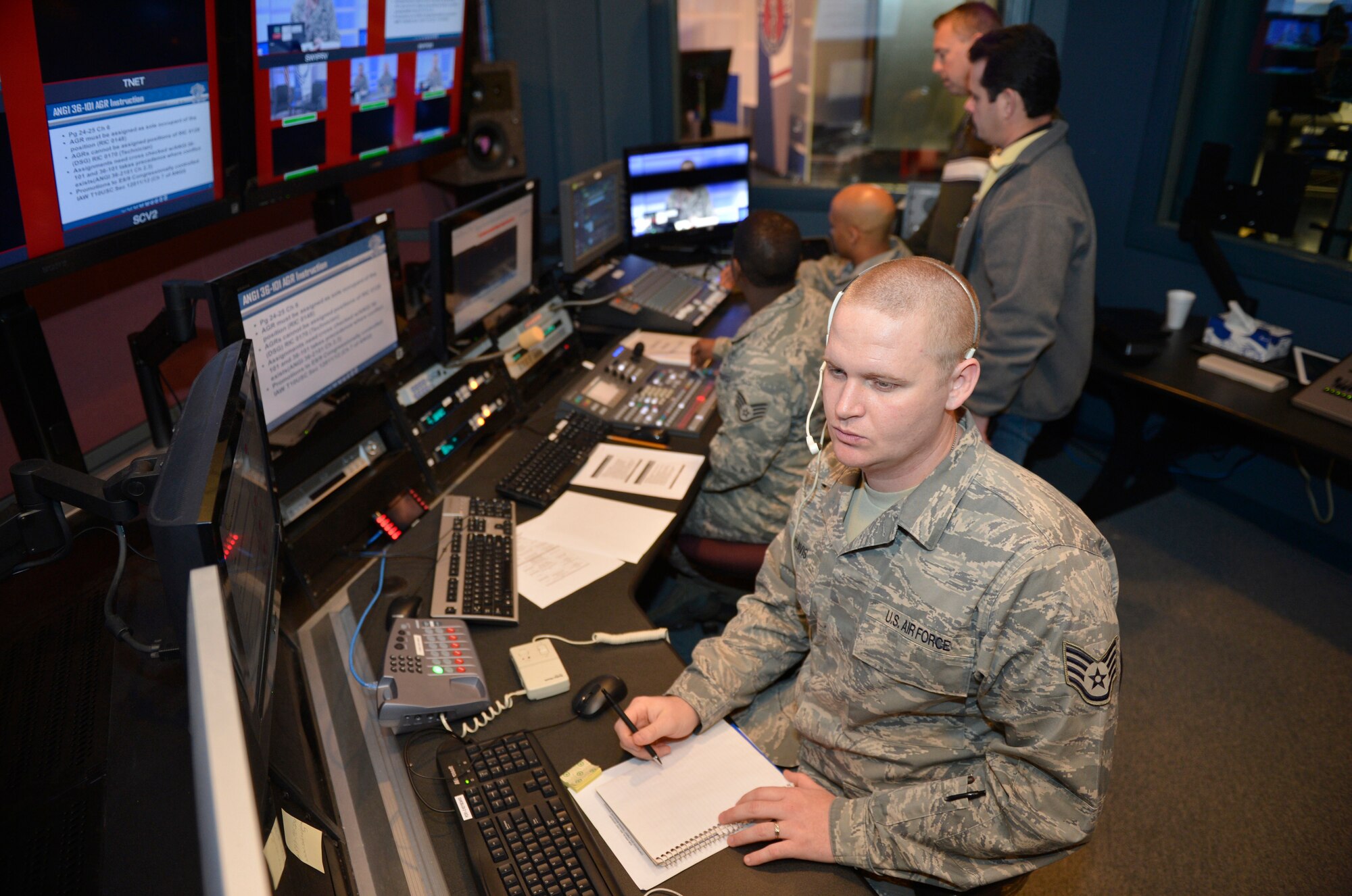McGHEE TYSON AIR NATIONAL GUARD BASE, Tenn. - Staff Sgt. Michael E. Davis, TEC/TV broadcast journalist at the I. G. Brown Training and Education Center here fields phone calls from callers wanting to speak with Chief Master Sgt. Michael Kennedy, the first sergeant functional manager for the Air National Guard during a live broadcast March 7, 2013. The broadcast, via the Warrior Network, was part of their continuous development training. (National Guard photo by Master Sgt. Kurt Skoglund)