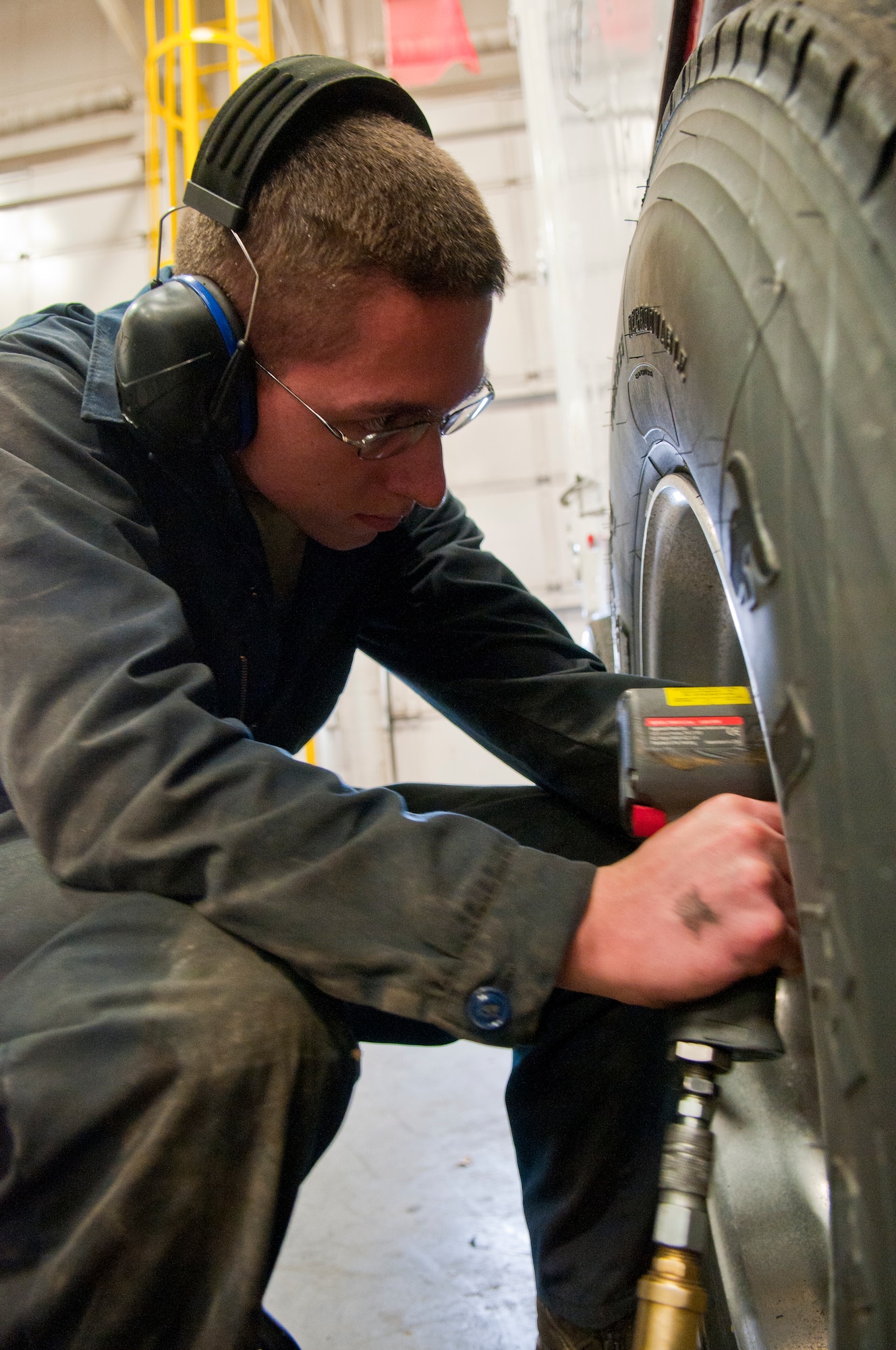 Airman 1st Class William Smith, 90th Logistics Readiness Squadron multipurpose vehicle mechanic, removes the lug nuts from a mobile maintenance vehicle tire in Bldg. 1245 March 4. Mobile maintenance vehicles play key roles in maintaining ICBMs, so keeping them operational is integral to continued nuclear surety. (U.S. Air Force photo by Airman 1st Class Jason Wiese)