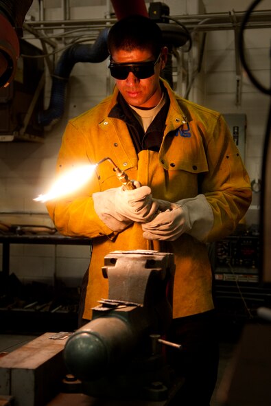 Airman 1st Class Alexander Pizarro, 90th Logistics Readiness Squadron multipurpose vehicle mechanic, lights an oxy-acetylene welder in Bldg. 1245 March 4. (U.S. Air Force photo by Airman 1st Class Jason Wiese)