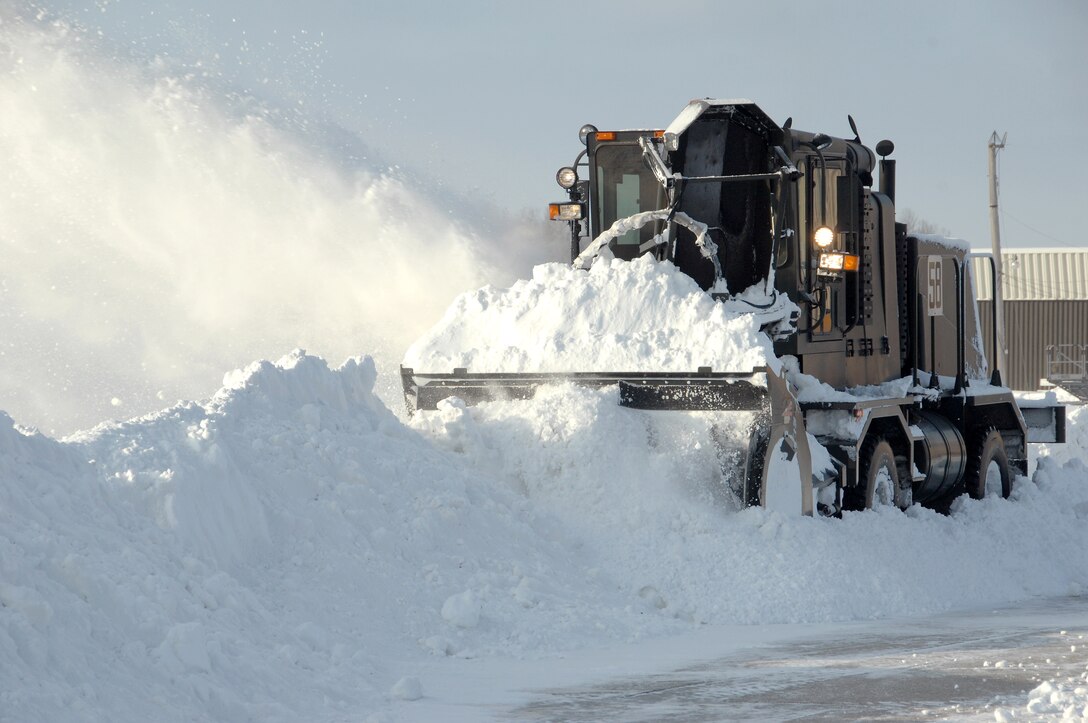 A snow blower operated by the 55th Civil Engineering Squadron’s heavy pavement shop removes a wall of snow from a taxiway at Offutt Air Force Base, Neb., Feb. 22. Offutt received eight inches of accumulation with the storm. (U.S. Air Force photo by Delanie Stafford/Released)