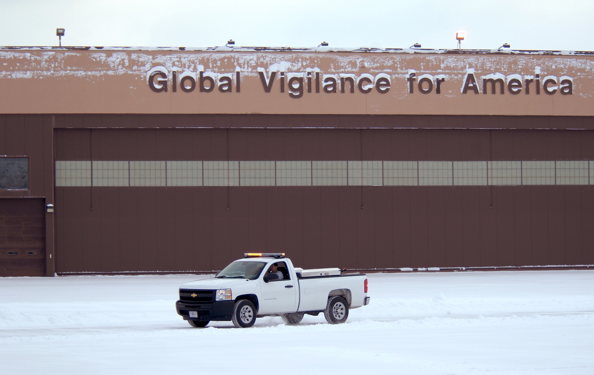 Kurt Kemp, a snow removal work leader commonly referred to as the “Snow Man” from the 55th Civil Engineering Squadron, coordinates snow clearing efforts from his pickup truck at Offutt Air Force Base, Neb., Feb. 22. Offutt received eight inches of accumulation with the storm. (U.S. Air Force photo by Delanie Stafford/Released)