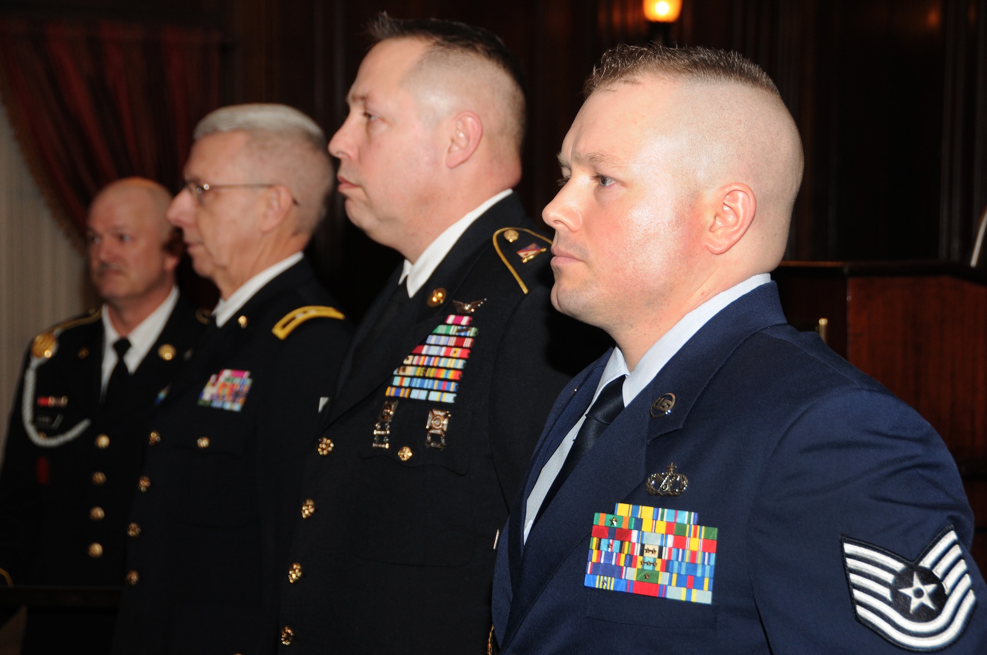 Pa. Air National Guardsmen, Tech. Sgt. Kevin Watson (right) and Pa. Army National Guardsmen, Sgt. 1st Class Bruce E. Facer, Sr. stand at attention next to Army Maj. Gen. Wesley E. Craig, adjutant general of Pa. as their citations are read for presentation of the Octavius V. Catto Medal on Feb. 23 at the Union League in Philadelphia. The award recognizes Pa. National Guard member’s contributions toward citizenship, volunteerism and commitment to duty.