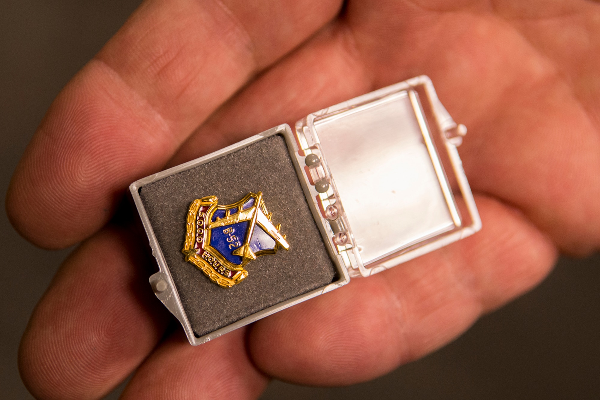 U.S. Air Force Lt. Col. Mark Ewart, 11th Bomb Squadron academics director, shows his B-52 5000 flying hours pin during a ceremony on Mar. 6, 2013, Barksdale Air Force Base, La. Prior to the ceremony, Ewart returned from a sortie in a 93rd Bomb Squadron B-52H Stratofortress where he achieved this career milestone. (U.S. Air Force photo by Master Sgt. Greg Steele/Released)