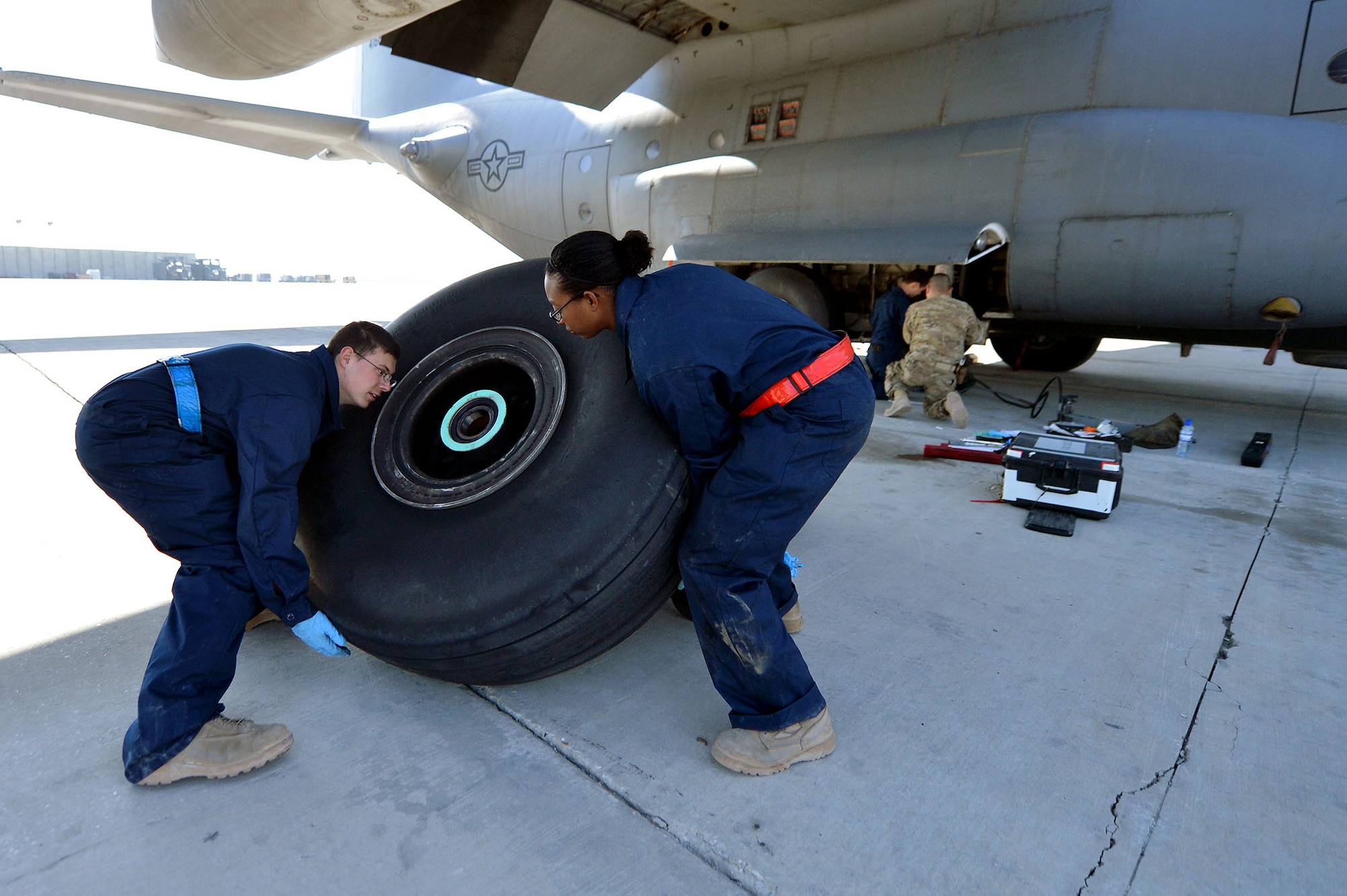 Crew chiefs assigned to the 455th Expeditionary Aircraft Maintenance Squadron replace a tire on a C-130 Hercules, March 6, 2013, on Bagram Airfield, Afghanistan. The crew is deployed from Little Rock Air Force Base, Ark. (U.S. Air Force photo/Senior Airman Chris Willis)