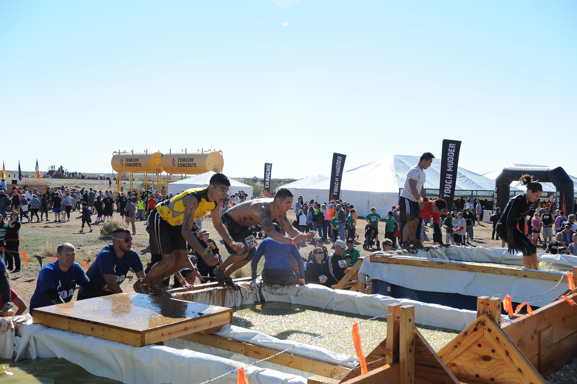 Airman 1st Class Reymundo Lopez, 56th Equipment Maintenance Squadron, prepares to jump into the Arctic Enema obstacle of the Tough Mudder challenge Feb. 23 in Mesa. The obstacle featured a pit filled with water and ice and is the second obstacle in the Tough Mudder course that has 21 obstacles featured on a 12-mile course. (U.S. Air Force photo/Airman 1st Class James Hensley)