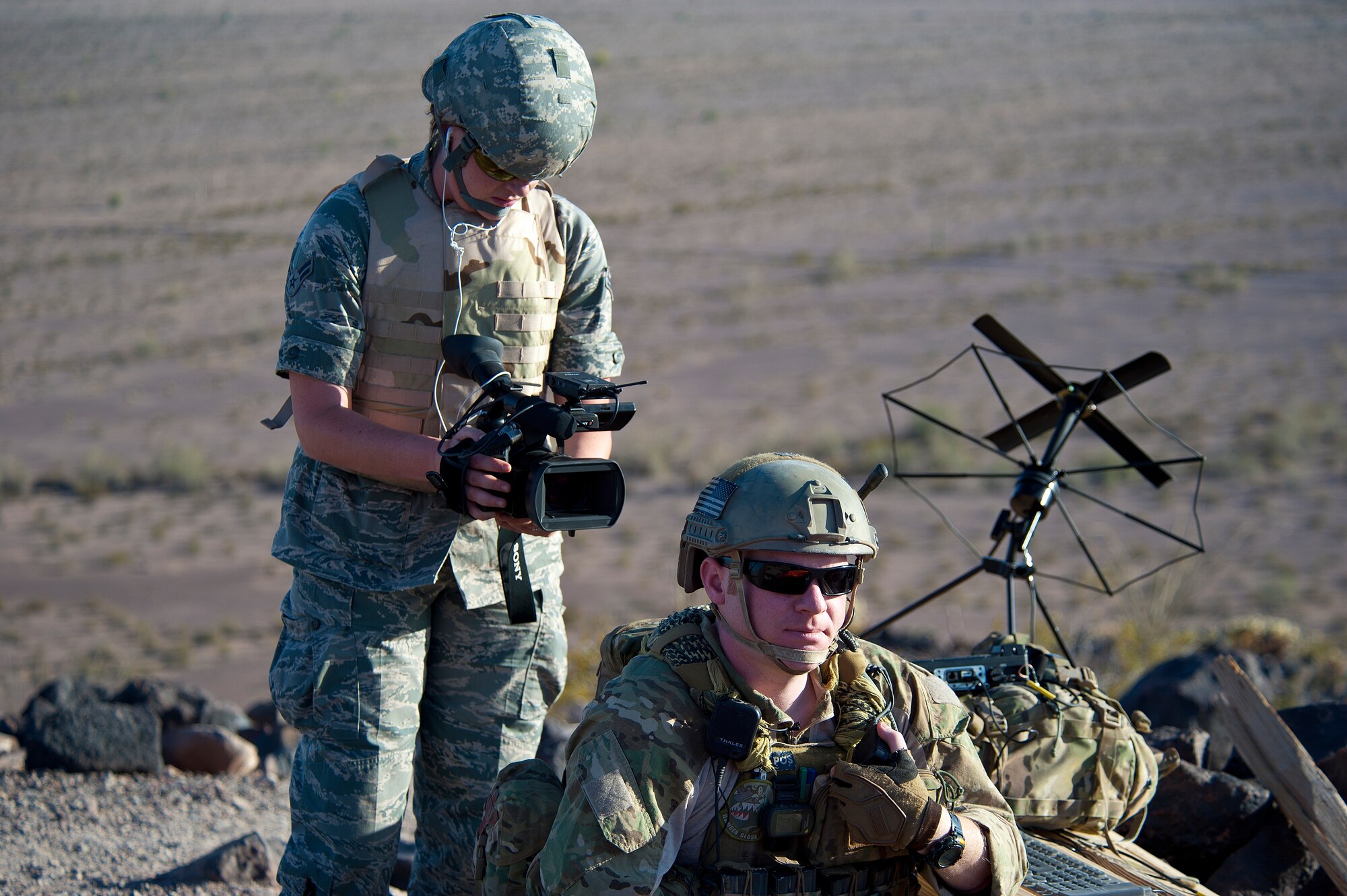Airman 1st Class Katherine Vaughn, 56th Fighter Wing Public Affairs broadcaster, captures footage of Staff Sgt. Jacob Torgerson, 116th Air Support Operations Squadron joint terminal attack controller, May 3, 2012, waiting for a response during the exercise at the Barry M. Goldwater Range. (U.S. Air Force photo/Staff Sgt. Jason Colbert)
