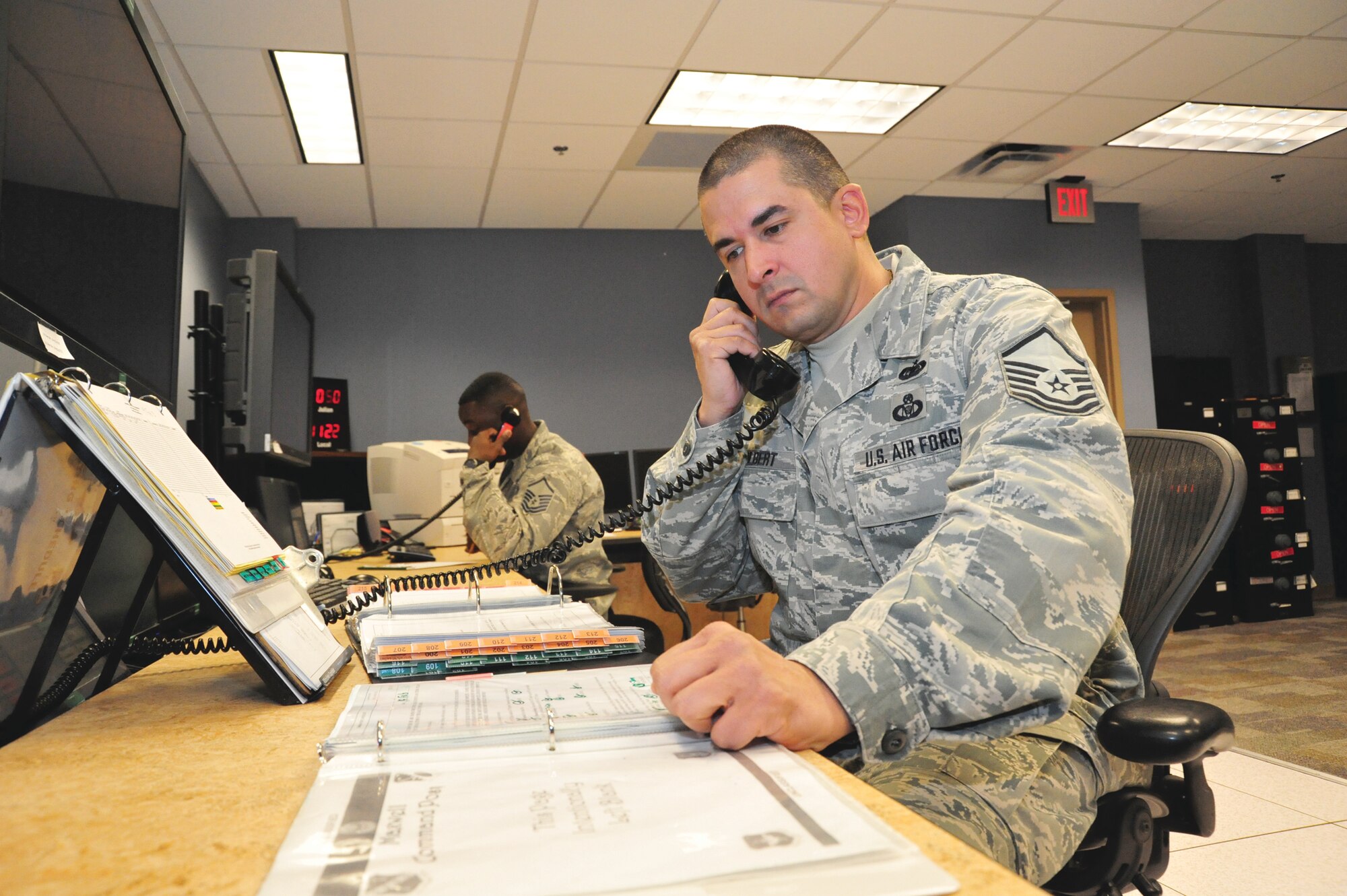 Master Sgt. Lamar Colbert, senior Air Reserve technician for the Maxwell command post, reviews a checklist used to respond to base emergencies here Feb. 19. Since the Maxwell command post combined in 2011, reservists work alongside active-duty Airmen to better facilitate 42nd Air Base Wing and 908th Airlift Wing missions. The 42nd ABW is the host organization for the base, while the Airmen of the 908th AW operate the seven C-130H Hercules stationed at Maxwell. (U.S. Air Force photo by Staff Sgt. Sandra Percival)