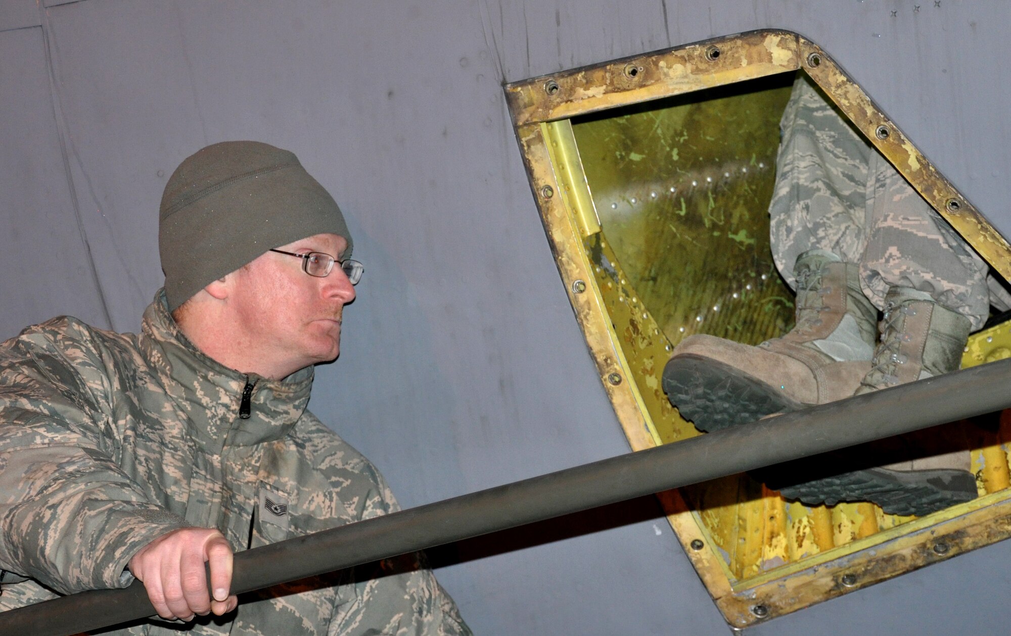 Tech. Sgt. Michael Mackey, 100th Aircraft Maintenance Squadron, monitors Airman 1st Class Brandon Baker, 100th AMXS, March 8, 2013, at a deployed location in southwest Europe. Baker was in the aft-tail compartment of a KC-135 Stratotanker replacing the pitch servo motor. Airmen from the 100th Air Refueling Wing deployed to southwest Europe in January 2013 as the 351st EARS to support French operations in Mali. Since Jan. 27, 2013, the 351st EARS Airmen have delivered more than 3-million pounds of fuel to French aircraft. (U.S. Air Force photo by Capt. Jason Smith)
