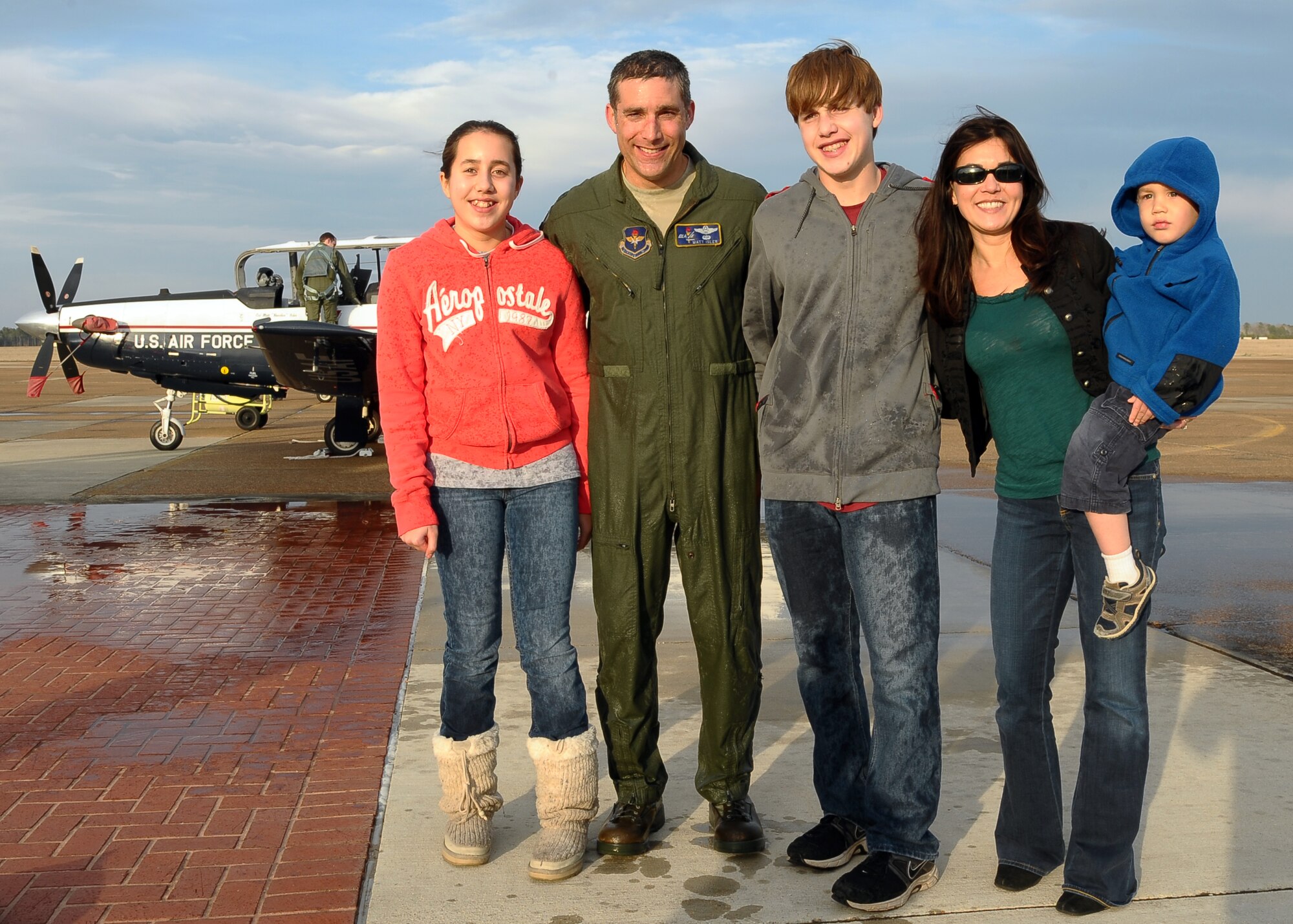 Col. Matt Isler poses with his family following his fini-flight on March 4.  Isler will be leaving his position as 14th Flying Training Wing Vice Commander to join Joint Base Pearl Harbor-Hickam, Hawaii as the Executive Officer to the Commander, Pacific Air Forces; Air Component Commander for U.S. Pacific Command; and Executive Director, Pacific Air Combat Operations Staff.  (U.S. Air Force Photo/Senior Airman Chase Hedrick)