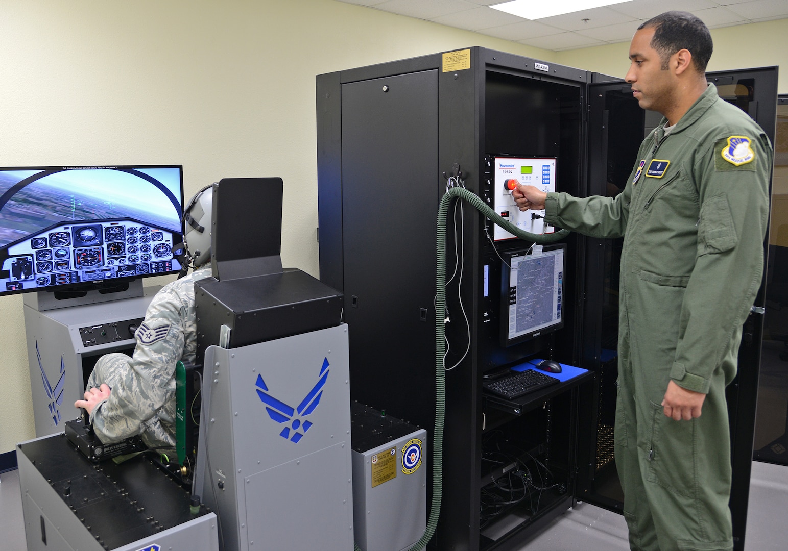 Air Force Staff Sgt. Jason Boyd and Tech. Sgt. Andre Scott, 359th Aeromedical Squadron Aerospace and Operational Physiology Flight craftsmen, conduct tests on the new hypoxia familiarization trainer Feb. 21 at Joint Base San Antonio-Randolph. (U.S. Air Force photo by Benjamin Faske/ Released)